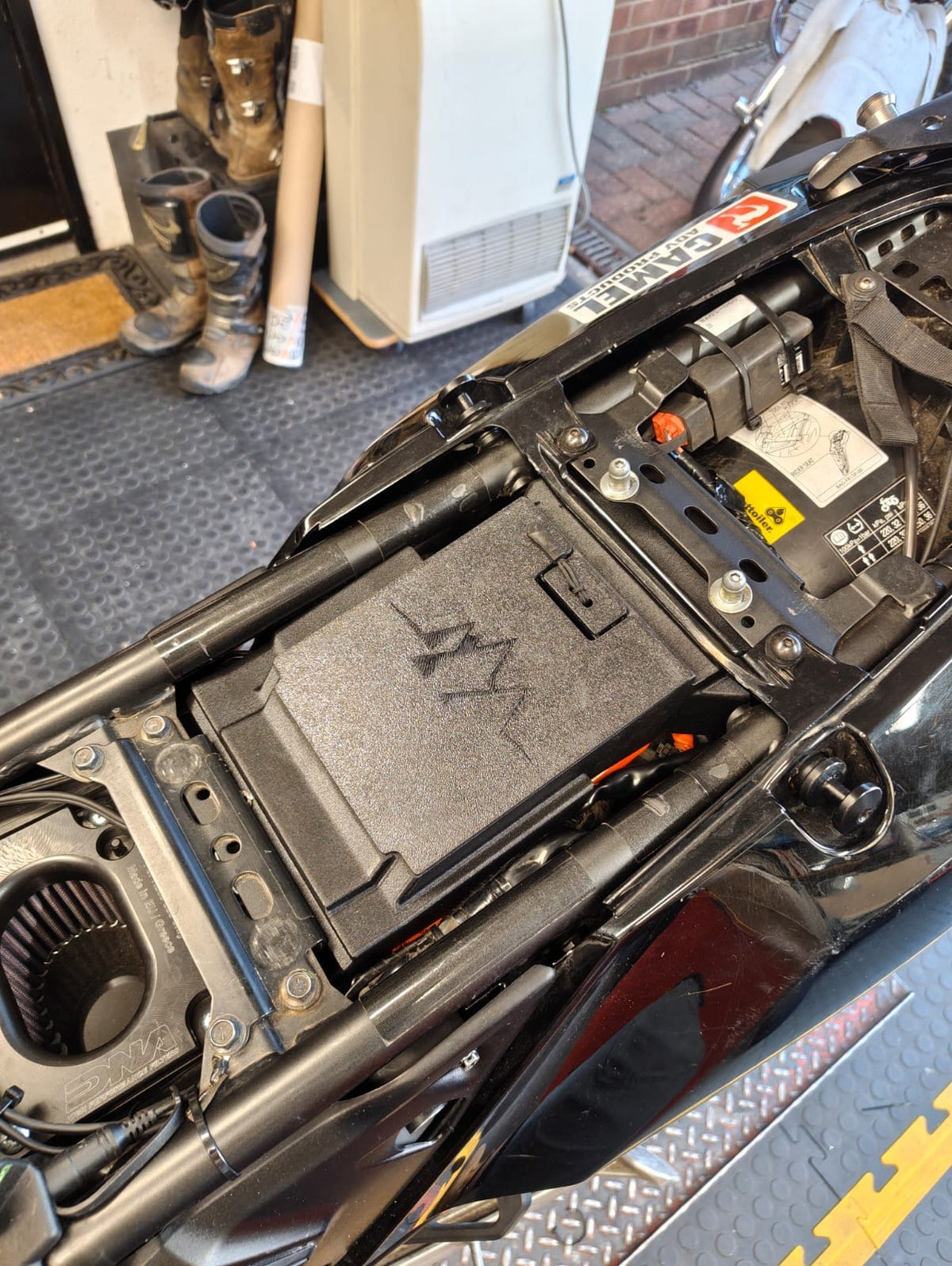 MotoCubby Nomad IV installed under the seat of a Yamaha Ténéré 700 World Raid