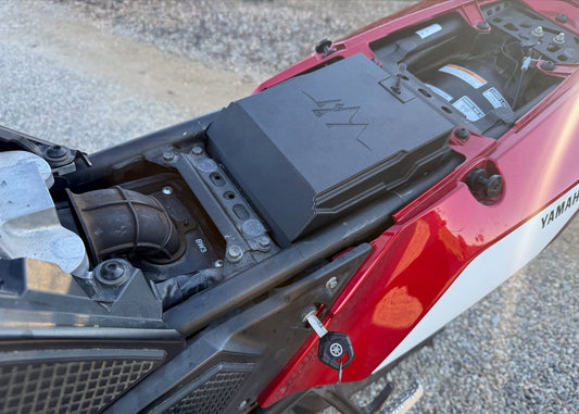 MotoCubby Scout installed on a Yamaha Ténéré 700 — close-up of the box seated in the bike showing the M logo lid alongside the airbox elbow