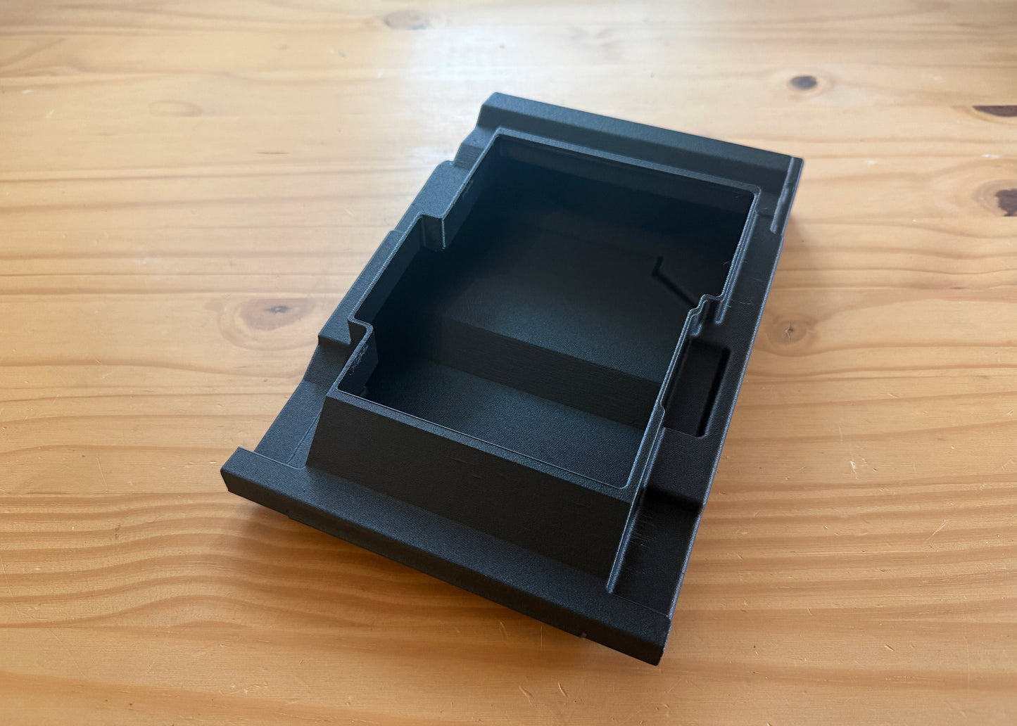 MotoCubby Nomad III under-seat storage for Yamaha Ténéré 700 — top-down view of the empty compartment showing depth and shape