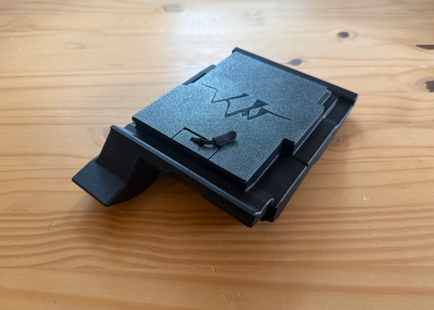 MotoCubby Nomad III under-seat storage for Yamaha Ténéré 700 — close-up of the lid with embossed M logo and pull-cord