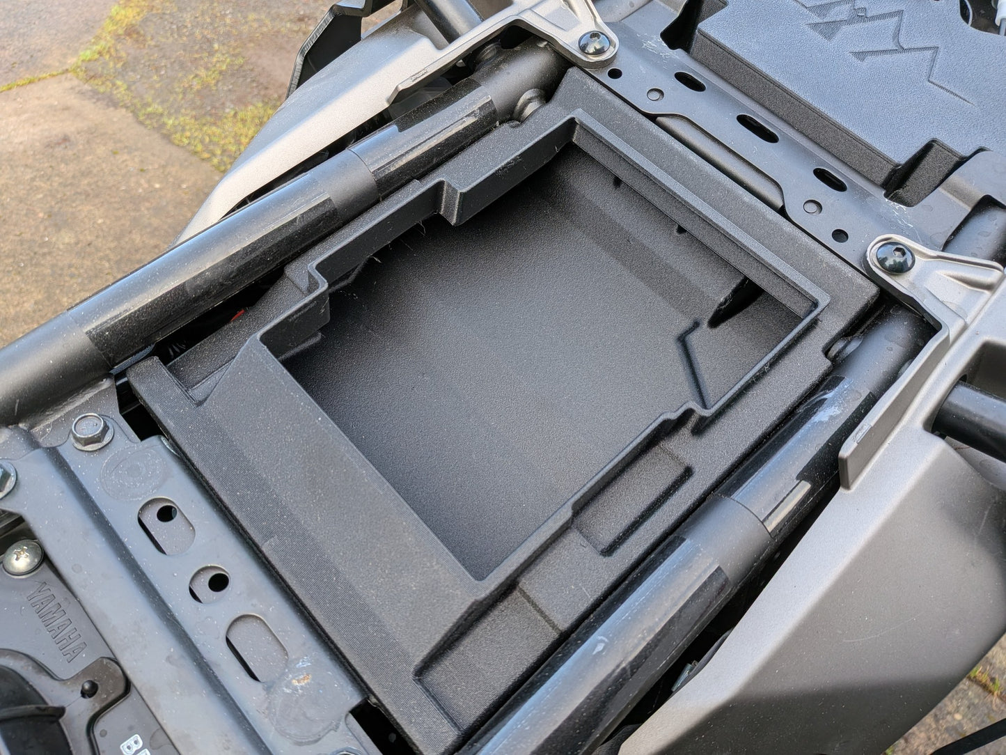MotoCubby Drifter II installed under the pillion seat of a 2025 Yamaha Ténéré 700 — empty box body showing the rear storage compartment